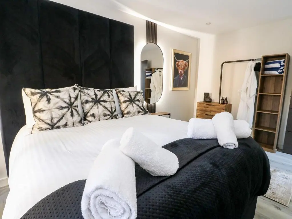 a bedroom with a bed with towels on it at Heilan Roo in Pitlochry