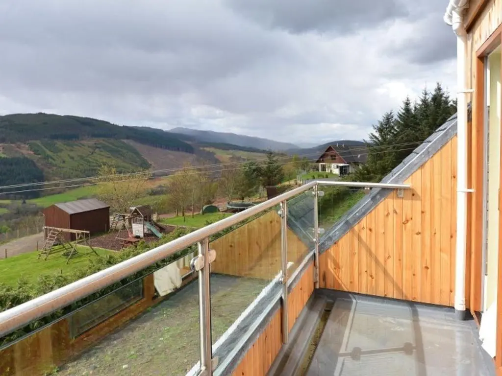 a balcony with a view of a countryside at Glen View Lodge in Inverness