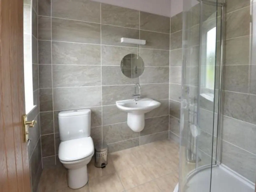 a bathroom with a toilet and a sink and a shower at Glen View Lodge in Inverness