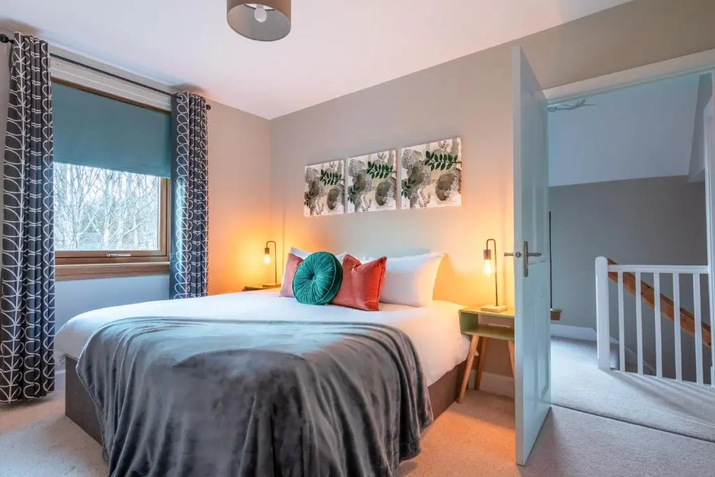 a bedroom with a bed and a window at Ness at the Park in Inverness