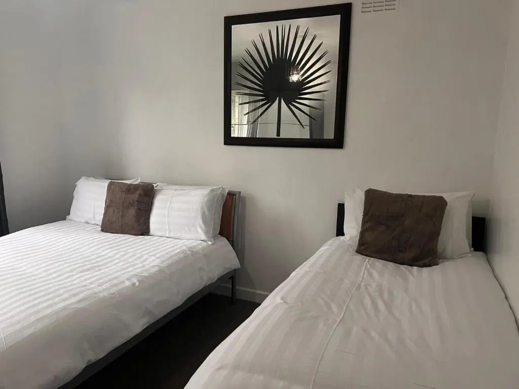 two beds sitting next to each other in a room at Shared House in Inverness in Inverness