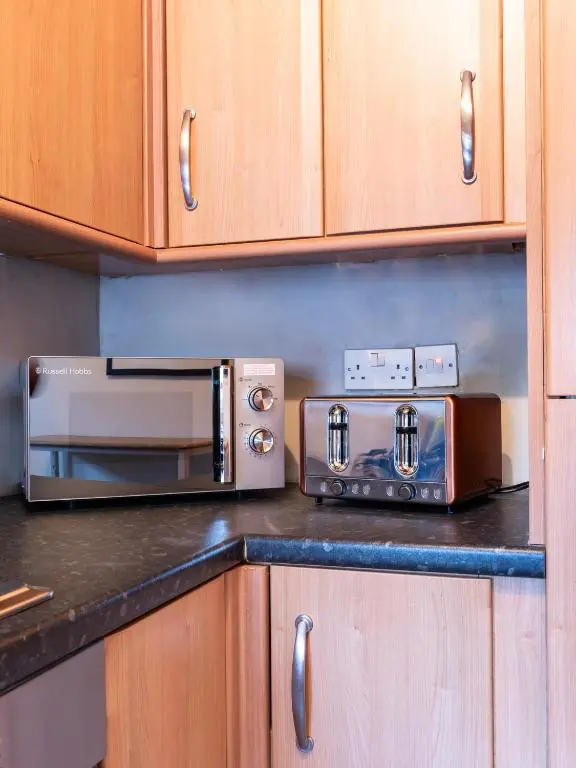 a kitchen counter with a toaster and a toaster oven at The Tartan Terrace in Inverness