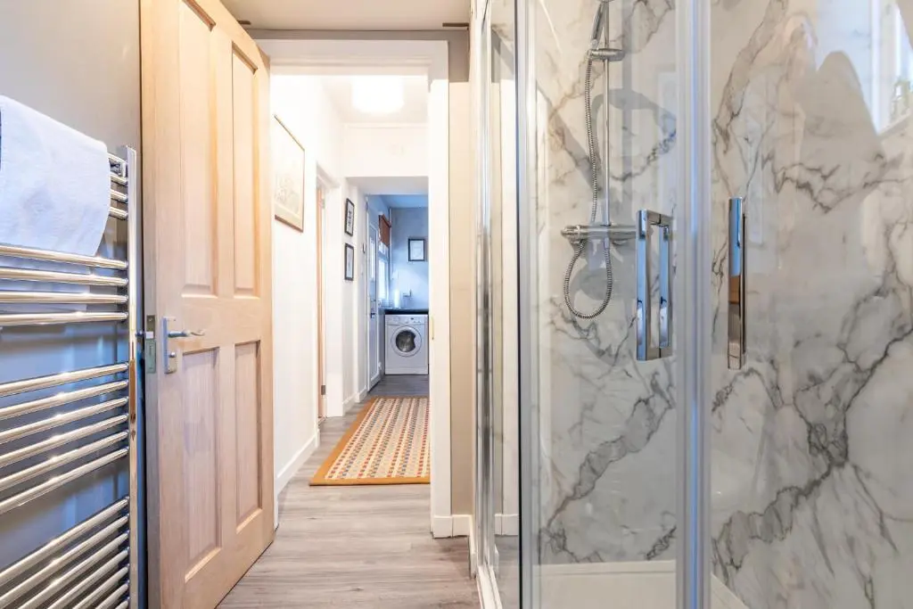 a bathroom with a shower with a glass door at The Tartan Terrace in Inverness