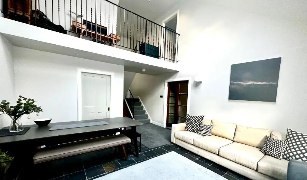 a living room with a couch and a piano at Findhorn Lodge in Findhorn