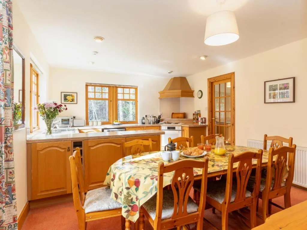 a kitchen and dining room with a table and chairs at Villa Osprey House by Interhome in Nethy Bridge