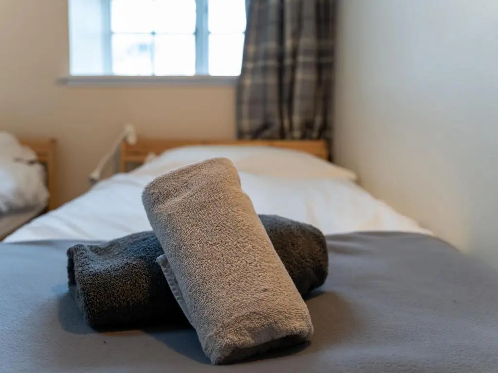 a pair of towels laying on top of a bed at Holiday Home 2 Railway Cottage by Interhome in Aviemore
