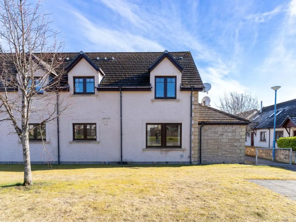 a large white house with blue windows at Apartment The Bruach by Interhome in Aviemore