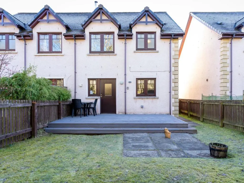 a detached house with a wooden fence at Holiday Home Cosagach Cottage by Interhome in Aviemore