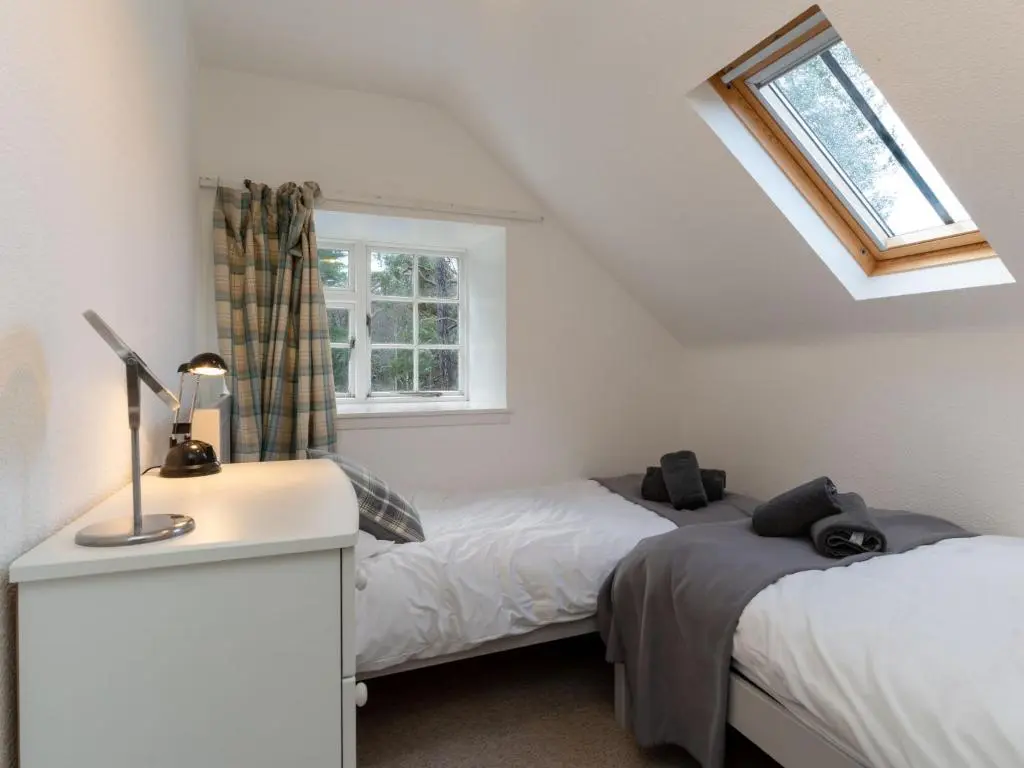 a bedroom with two beds and a window at Holiday Home 1 Railway Cottage by Interhome in Aviemore