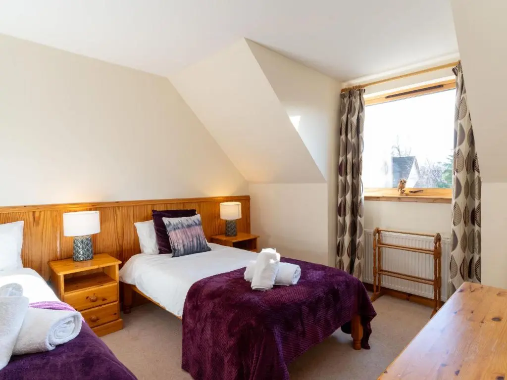 a bedroom with two beds and a window at Villa Craigmore Lodge by Interhome in Aviemore