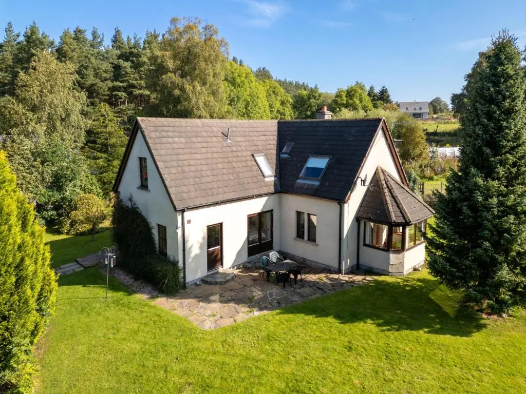an aerial view of a white house in a field at Holiday Home Lower Curr by Interhome in Skye of Curr