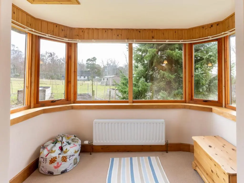 a room with windows and a radiator and a bench at Holiday Home Lower Curr by Interhome in Skye of Curr