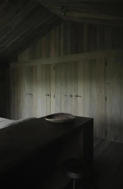 a room with a bed and a table and a stool at Laggan Cottage - Charming home along River Gairn with unique panoramic room in Ballater