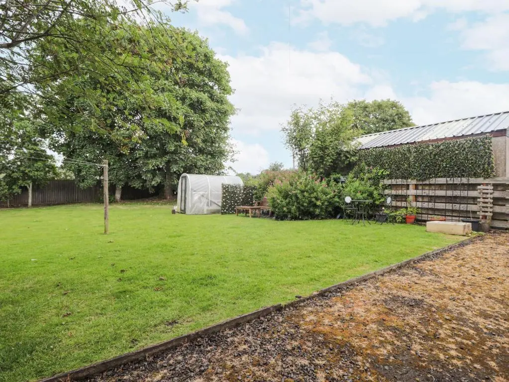a garden with a tent in the yard at Rowan Tree House in Brora