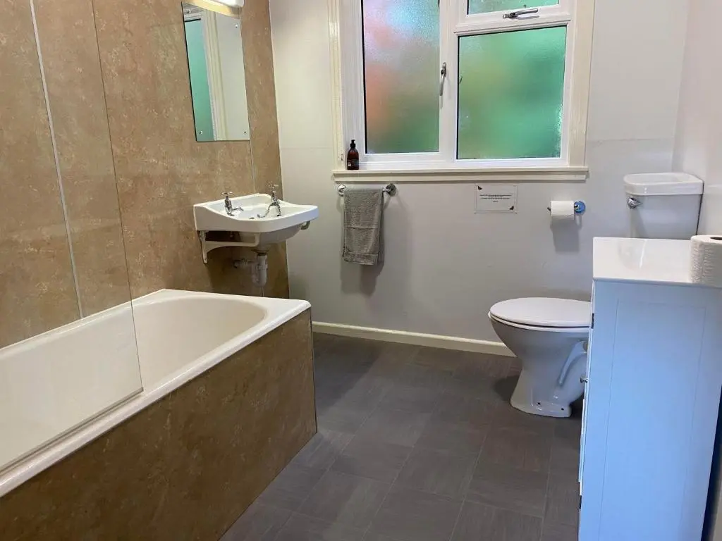 a bathroom with a tub sink and a toilet at Burnside Chalet on Reelig Estate in Kirkhill