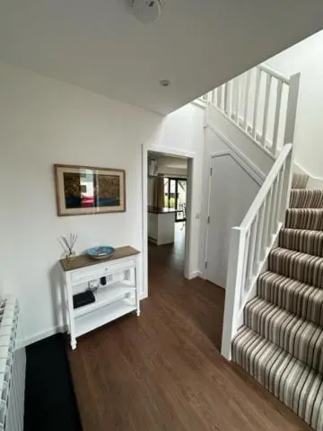 a room with a staircase and a stair case at Highland Holiday Home in Contin