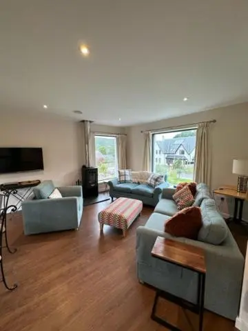 a living room with two couches and a tv at Highland Holiday Home in Contin