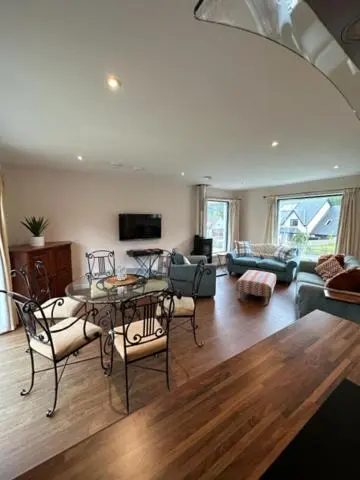 a living room with a table and chairs at Highland Holiday Home in Contin