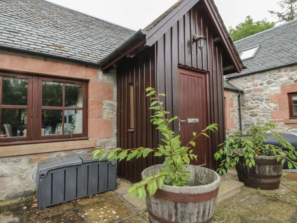 a house with a plant in front of it at The Milk House in Fortrose