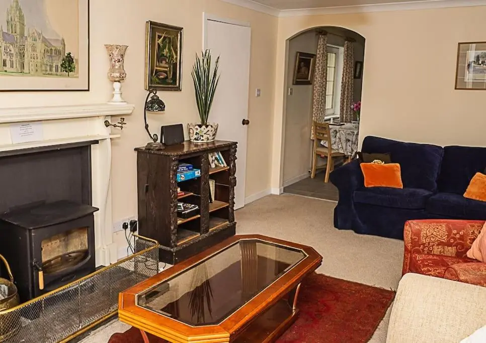 a living room with a couch and a fireplace at West Lodge 3 bedrooms, near golf course and river in Turriff