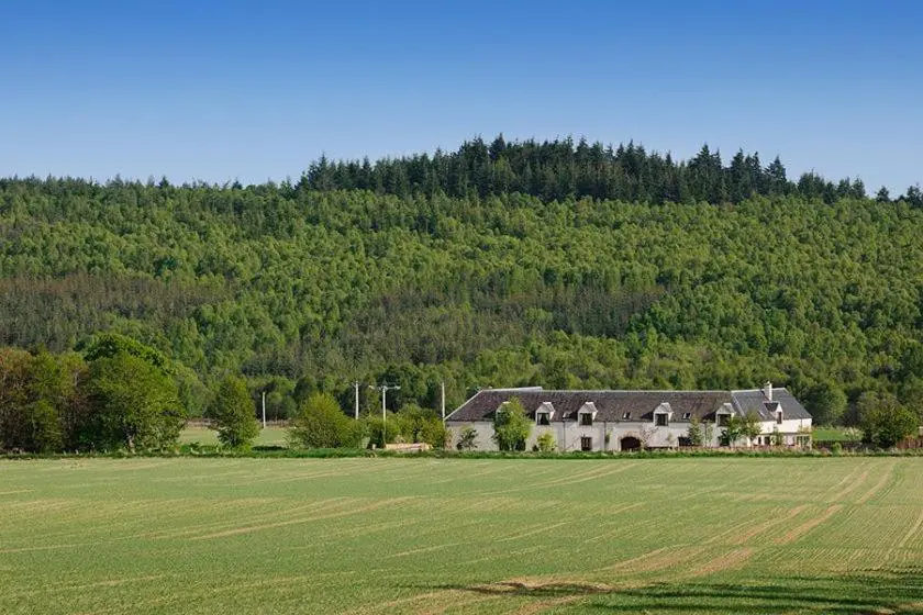 a large house in the middle of a field at Mackenzie in Belmaduthy