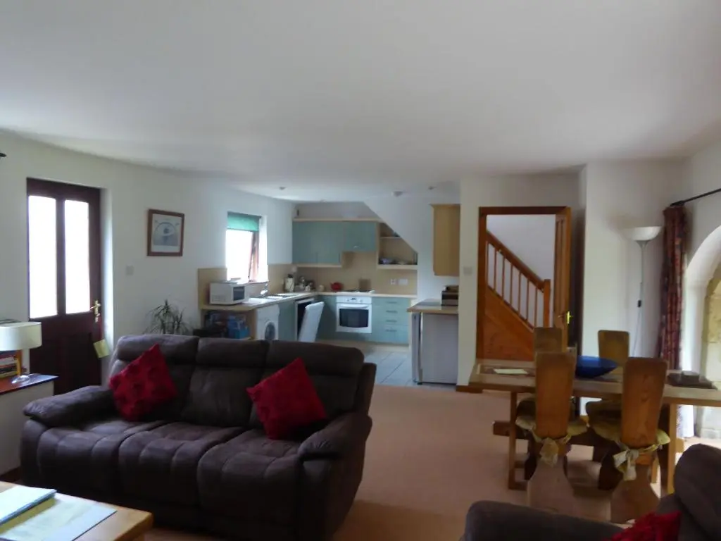 a living room with a couch and a table at Mackenzie in Belmaduthy