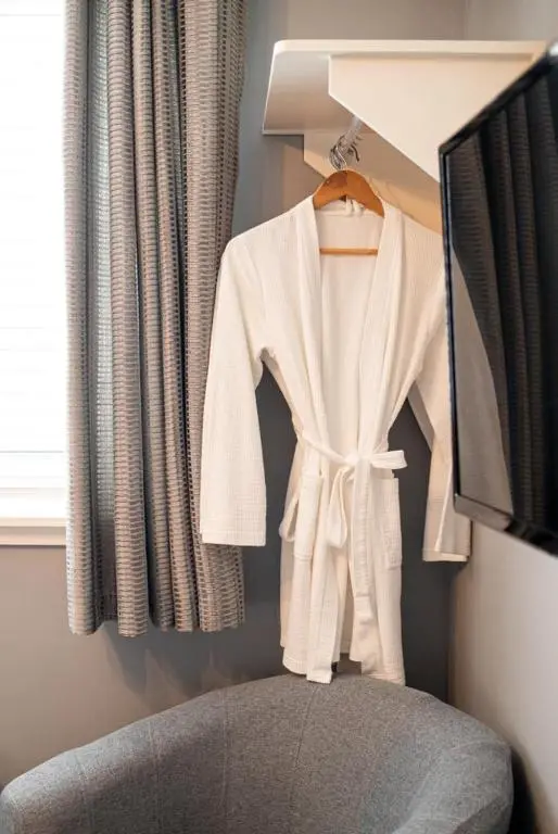 a white robe hanging on a rack in a room at Fonthill Bed and Breakfast Nairn in Nairn