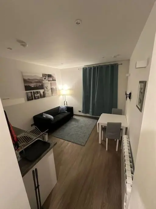 a living room with a couch and a table at Riverview Apartment, Inverness in Inverness