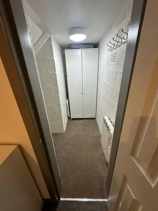 a hallway with a door leading to a room with a hallway at Riverview Apartment, Inverness in Inverness