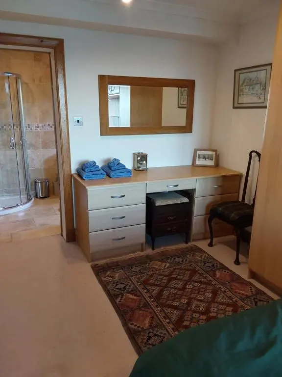 a room with a desk with a mirror and a chair at Ceol Na Mara (Music of the Sea) in Rosemarkie