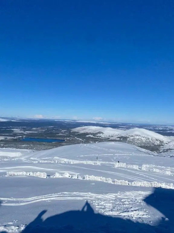 an aerial view of a snow covered field with snow at Old School in Kingussie