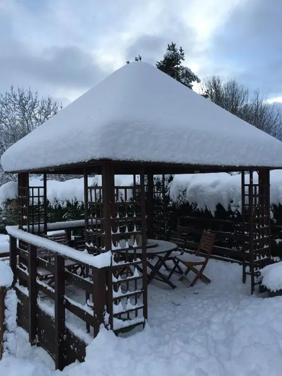 a gazebo with snow on top of it at Ardlogie Guest House in Aviemore