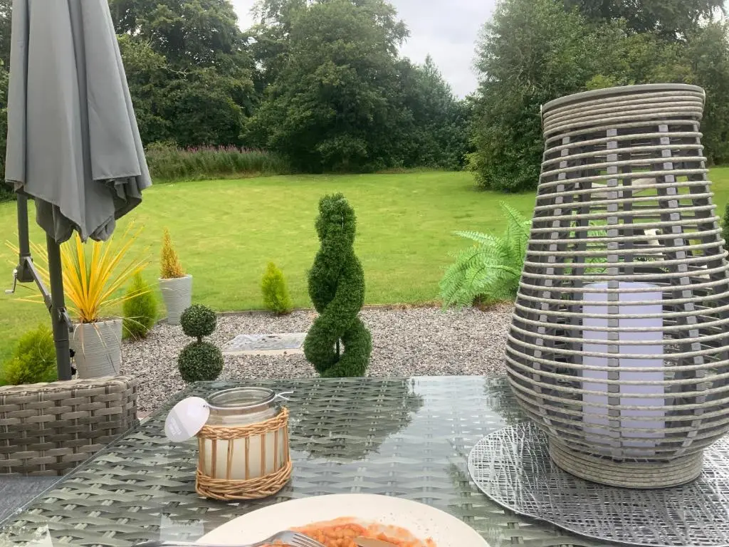 a table with a plate of food on a patio at Antfield House in Inverness