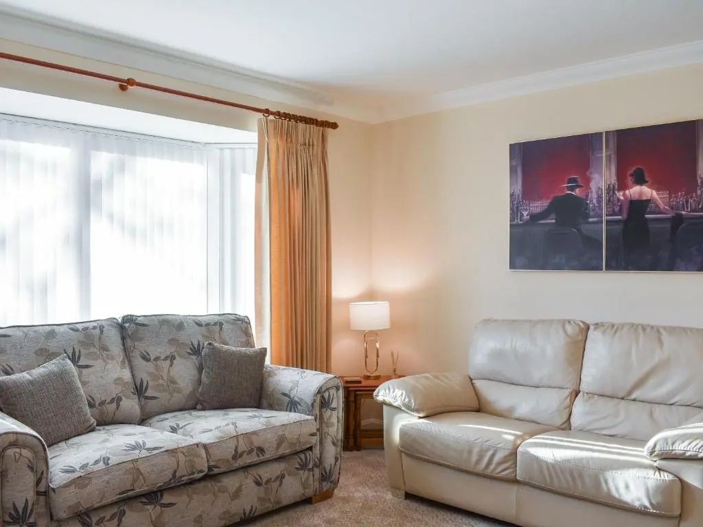 a living room with a couch and a chair at Rycon in Turriff