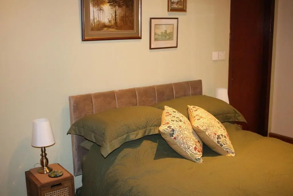 a bedroom with a bed with two pillows on it at Invercassley cottage in Lairg
