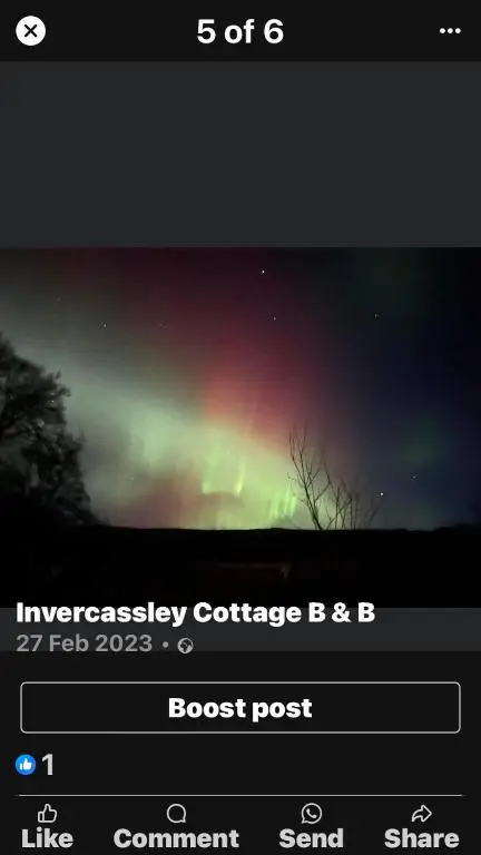a screenshot of a screen with a picture of the northern lights at Invercassley cottage in Lairg