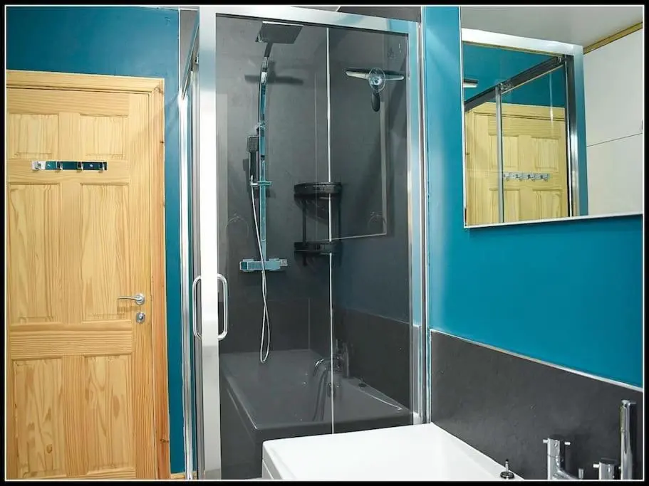 a bathroom with a shower with a toilet and a sink at Town centre house, Hot tub, Cinema room and Gym in Aviemore