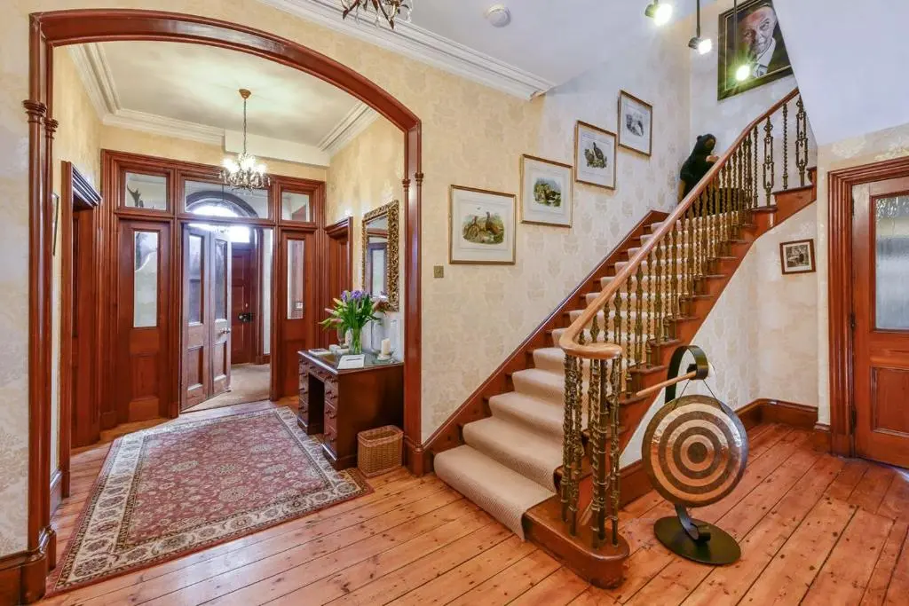 a hallway with a spiral staircase in a home at Caledonian Lodge in Croick