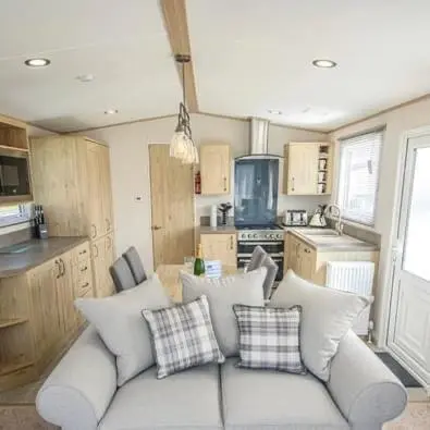 a living room with a couch in a kitchen at Robyn\u2019s Nest in Lybster