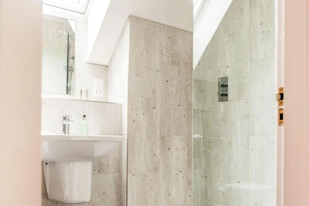 a bathroom with a sink and a shower at Greenhill Cottage in Evanton