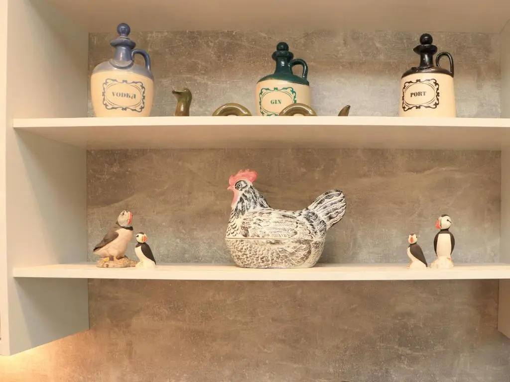 a shelf with a chicken and penguins on it at Pine Marten in Dornoch