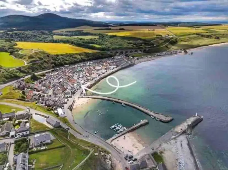 an aerial view of a beach with a white circle in the water at Cullen Seaside Cottage in Cullen