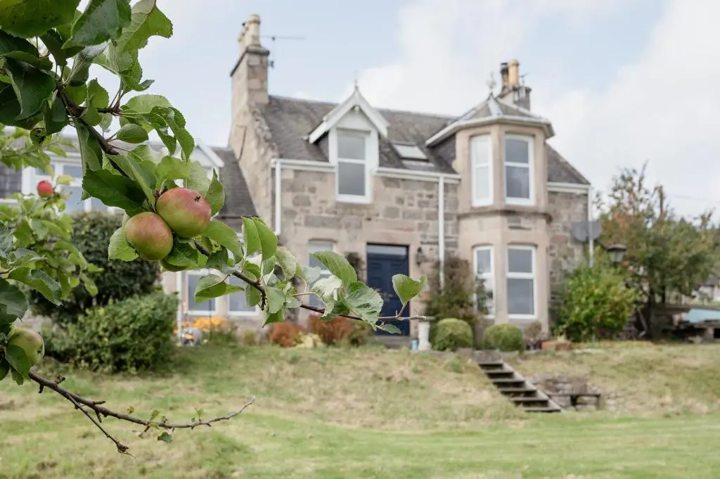 a house with an apple tree in front of it at The Larches in Skye of Curr