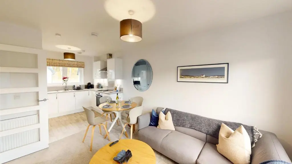 a living room with a couch and a table at 26 Ben Avon in Aviemore