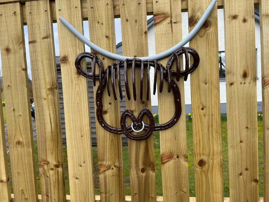 a pair of hoses hanging on a wooden fence at Rowan Bank Retreat in Fort Augustus