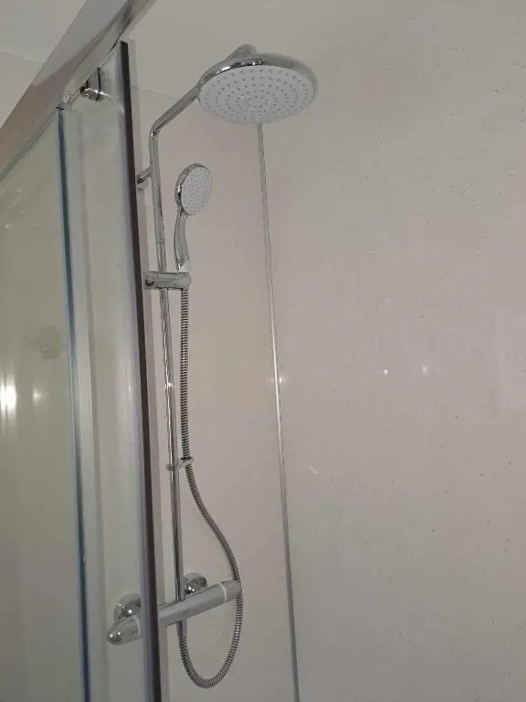 a shower with a shower head in a bathroom at Rowan Bank Retreat in Fort Augustus
