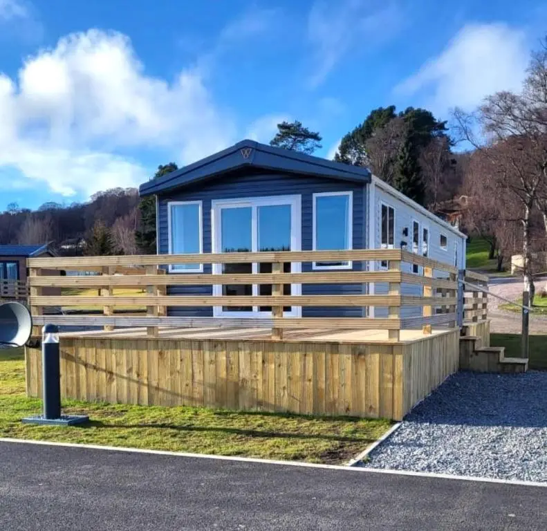 a modular home with a wooden fence at 95 Grantown in Grantown on Spey