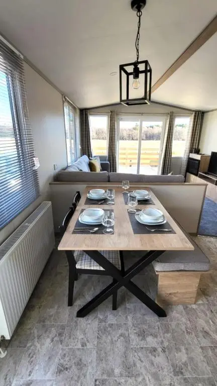 a dining table in a living room with a couch at 95 Grantown in Grantown on Spey