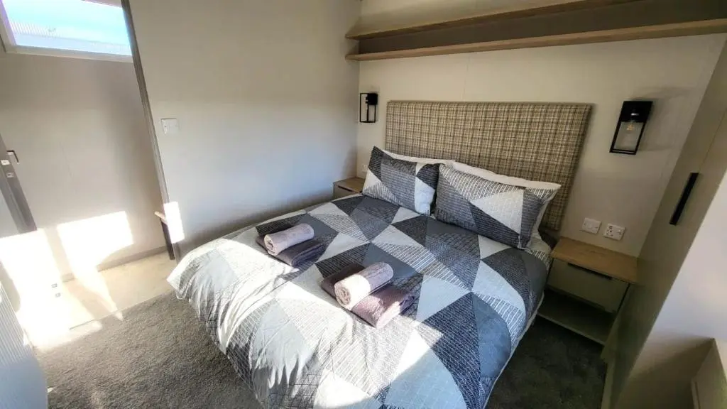 a bedroom with a bed with pillows on it at 95 Grantown in Grantown on Spey