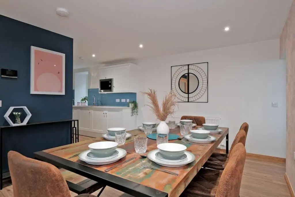 a dining room with a wooden table with chairs at Cliff Top Cottage with Sea Views in Portknockie